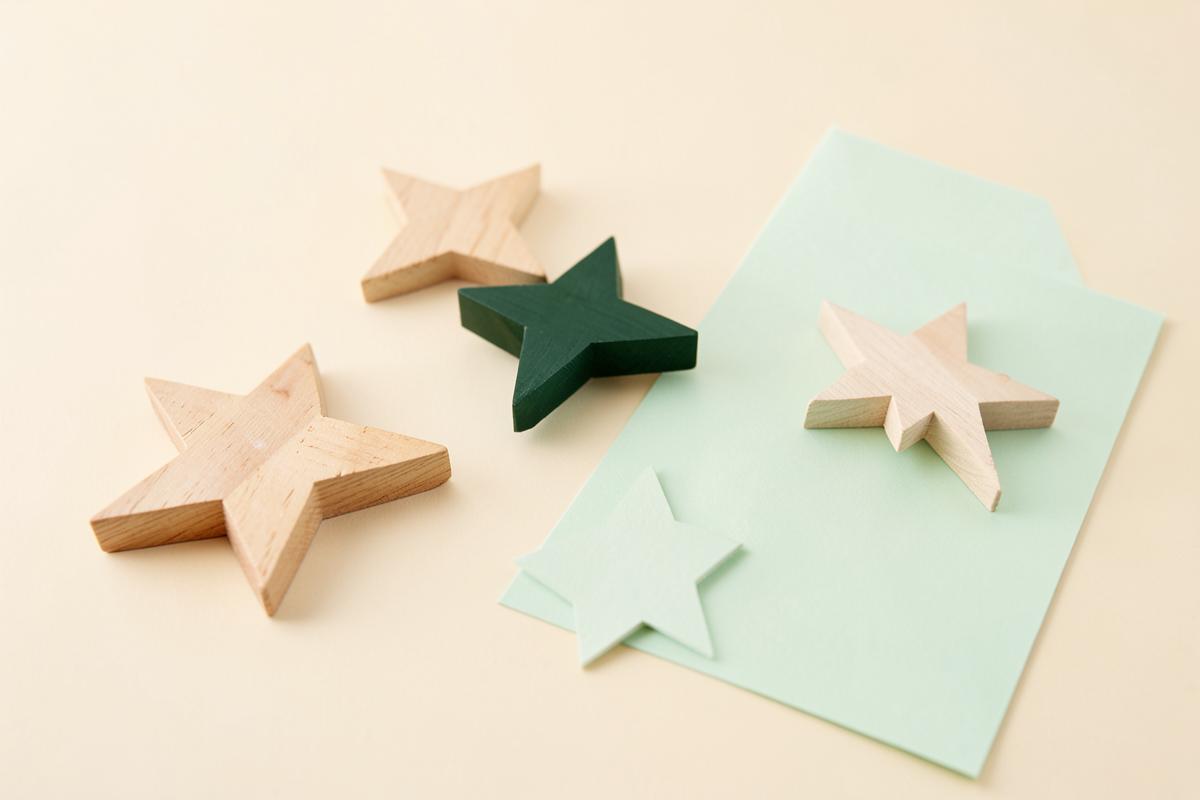 Wooden stars arranged on a cream surface