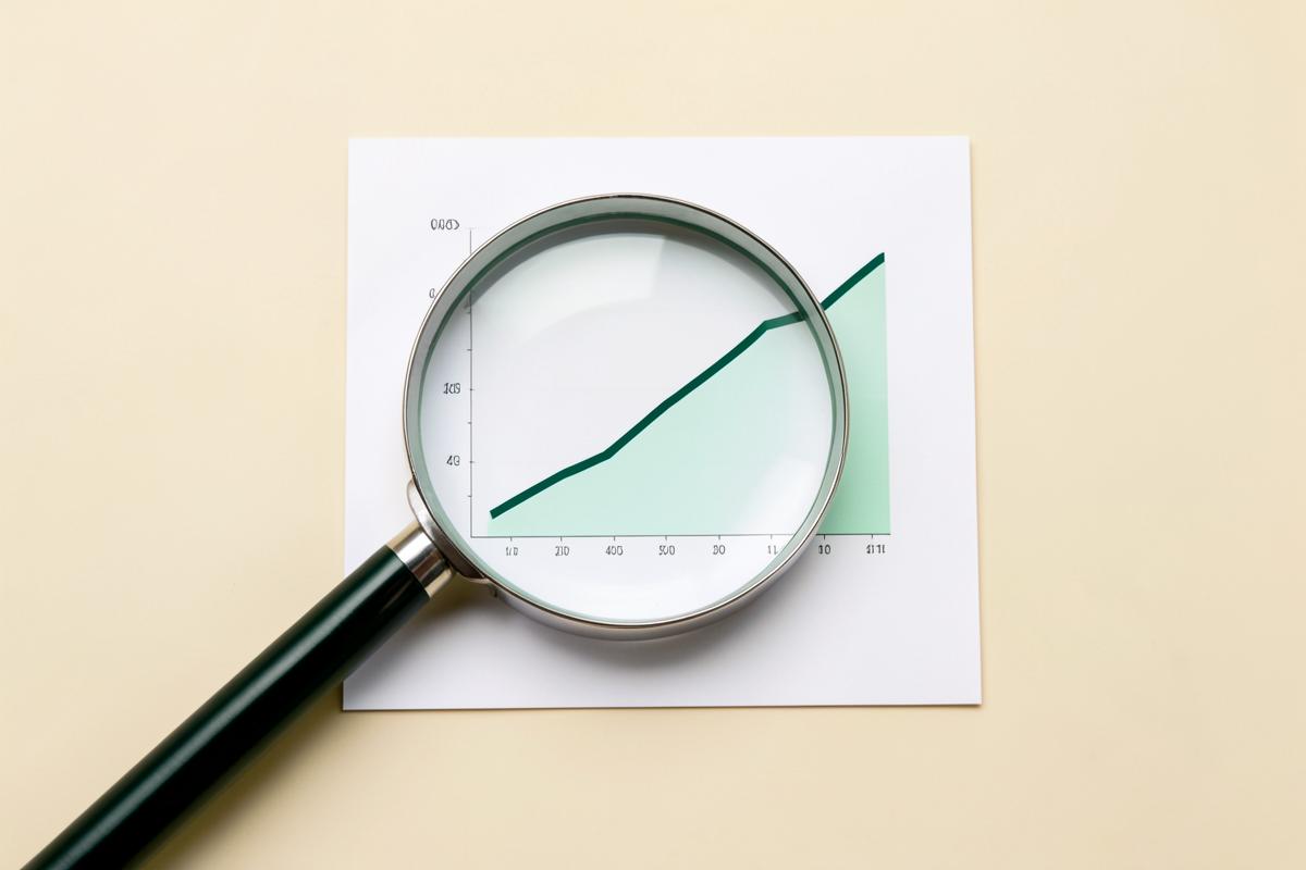 Magnifying glass over a rising performance chart